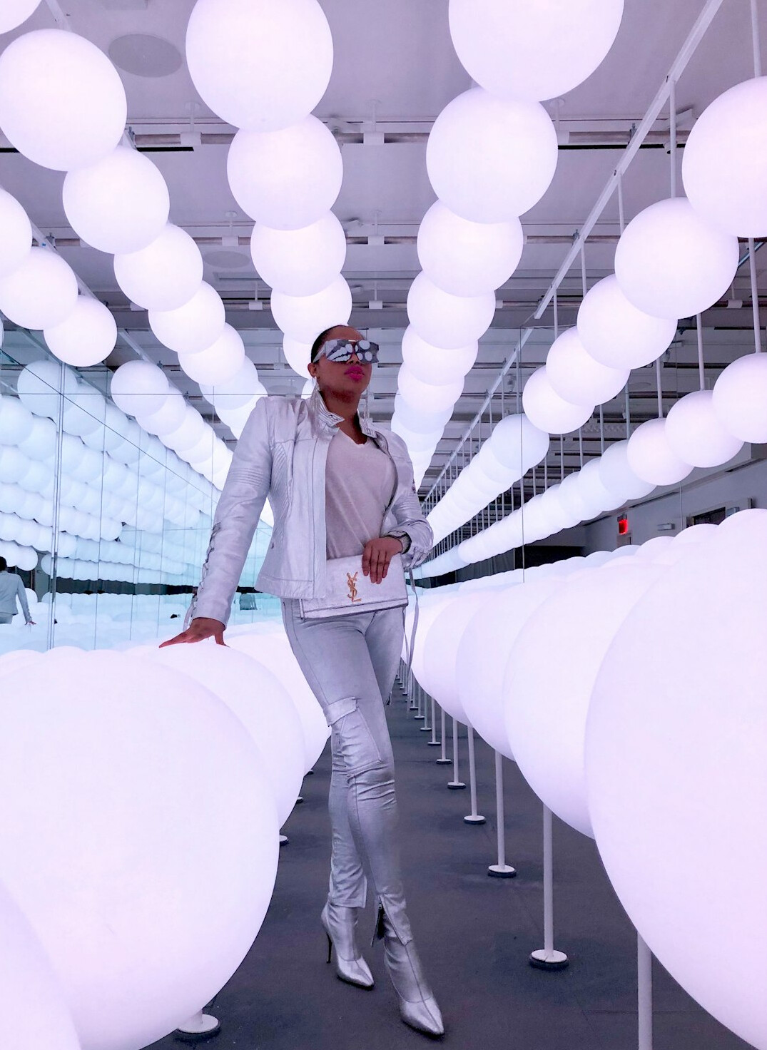 Fashion runway show with model walking under bright lights
